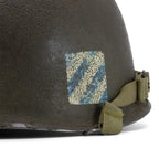 Casque complet Battle Battered 3rd ID 7th Infantry Regiment 1st Battalion 1st Lt gros plan de l'insigne de la 3rd Infantry division patiné.