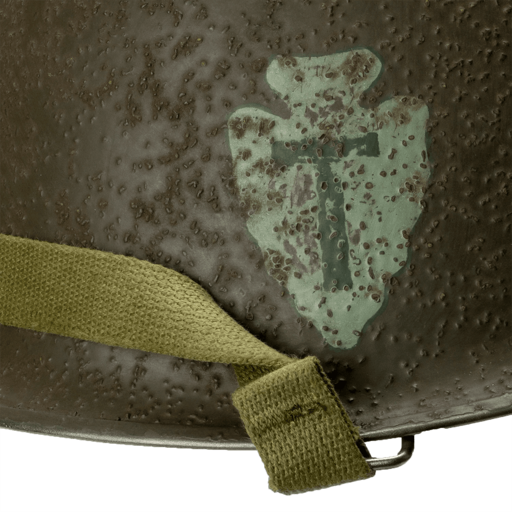 Coque de casque US M1 Battle Battered 36th Infantry Division vue en gros plan de l'insigne droit